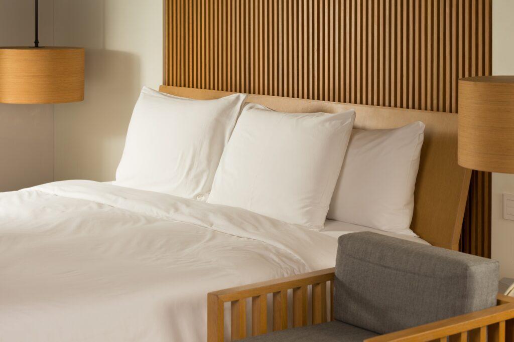 Elegant hotel room with a cozy, well-made bed.